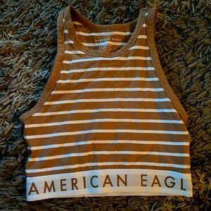 American Eagle crop top tank with elastic band around bottom 
Size xs
Tan/white